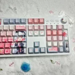 Exclusive Sakuraba Ema Magical Girl Dye-Sub PBT keycaps set. Vivid anime-inspired art and mystical witch trial aesthetic are seen from various angles.