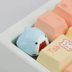 Handcrafted resin Samezu Shark Artisan Keycap, an ESC key. Displaying the whimsical, cute cartoon shark design and unique marine art from multiple angles.