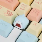 A playful, handcrafted Samezu shark artisan keycap for the ESC key, showcasing its whimsical cartoon design and intricate details from multiple angles.