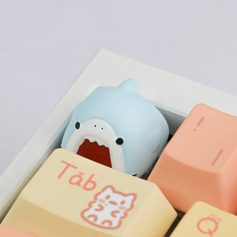 Close-up of a playful, cute handcrafted Samezu shark artisan keycap, perfect for an ESC key, featuring a whimsical cartoon shark design.