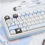 Pixel Cat Keycap Set: Multi-angle views showcasing unique pixel art cats, tranquil sea salt PBT design, and retro-cute aesthetic.