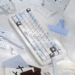 Multiple views of the Pixel Cat Sea Salt PBT Keycap Set, showcasing charming pixel art cats in a tranquil sea salt palette and its unique design.