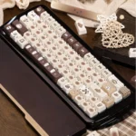 Detailed view of the Adorable Siamese Cat Cafe PBT Dye-Sub Keycaps Set, showcasing whimsical feline illustrations and cozy coffee motifs from an artistic angle.