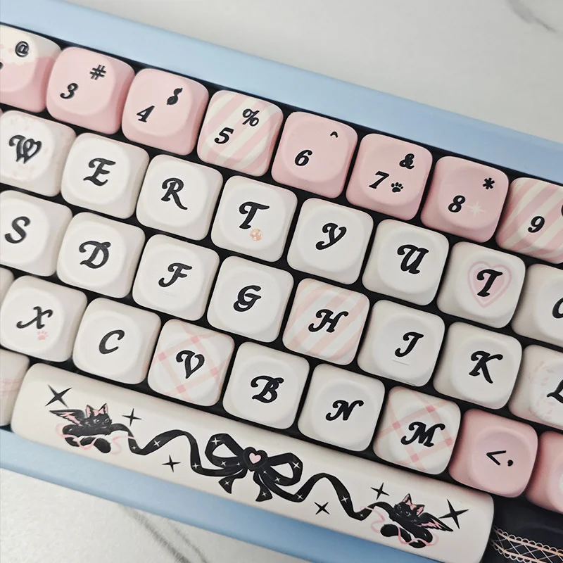 A close-up view of the playful PBT Sweetheart Black Cat Keycap Set, showcasing adorable black cat motifs and heart accents on smooth MOA profile.