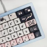 Playful PBT Sweetheart Black Cat Keycap Set, showcasing charming black cat motifs and heart accents on smooth MOA profile keys from a detailed angle.