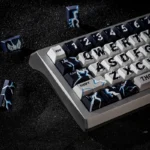 Close-up of a premium Thor keycap set, showcasing dynamic Mjolnir and lightning motifs on multiple keys from a different angle, emphasizing its thunder motifs.