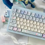 Close-up of Dreamy Tipsy Bubbles PBT Dye-Sub Keycaps set, showcasing delicate pastel gradients and ethereal bubble patterns from a top-down artistic angle.