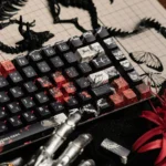 A detailed view of the Tokyo Ghoul Ken Kaneki PBT keycaps set, highlighting the unique side-printed shine-through legends and dark anime artistry.