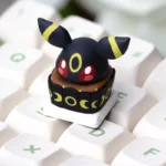 Charming handcrafted Umbreon 'Cake' artisan keycap, a meticulously sculpted Pokemon design with a sweet, cake-inspired aesthetic, perfect for ESC key.