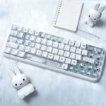 Miffy PBT shine-through keycaps set. Close-up photos reveal iconic Miffy art, clean white PBT, and playful translucent side-engraved legends.