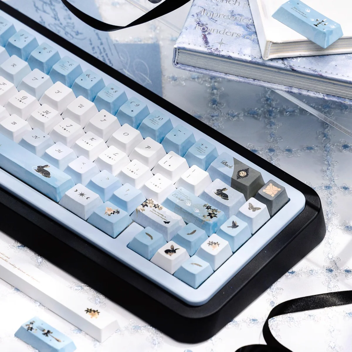 Wild Lily Notebook PBT & Transparent PC keycaps set. Angled view highlights delicate floral art, vintage journal elements, and unique transparent design.