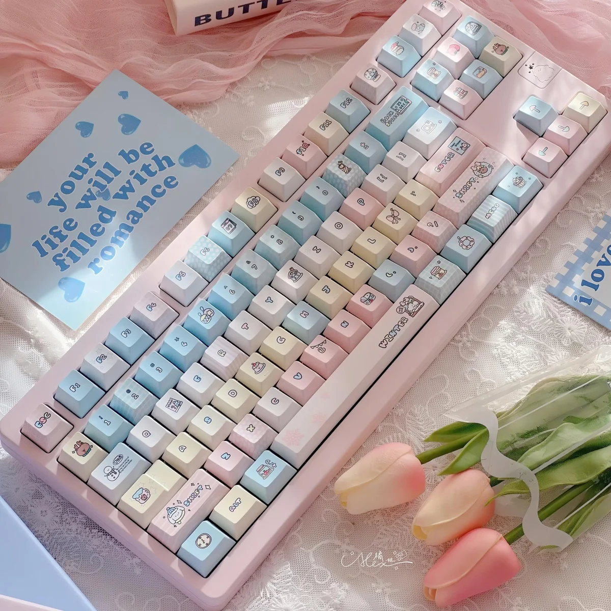 Close-up of Serene Winter PBT Keycap Set, showing durable PBT and crisp dye-sub legends. The cool hues artistically evoke a tranquil winter.
