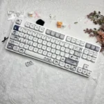 A whimsical collection of Working Penguin PBT Dye-Sub keycaps set, showing the unique MOA set from various angles with charming cartoon penguins.