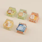 Close-up of a whimsical handcrafted Camping Biscuit artisan keycap, featuring a charming miniature fox by a cozy campfire, highlighting its intricated design.