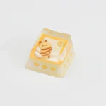 Unique handcrafted artisan ESC keycap featuring a whimsical miniature bee on a cozy camping biscuit. Perfect for a playful, nature-inspired keyboard.
