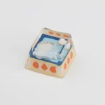Handcrafted ESC artisan keycap: a whimsical little shark enjoying a cozy camping biscuit scene. Unique and charming for custom keyboards.
