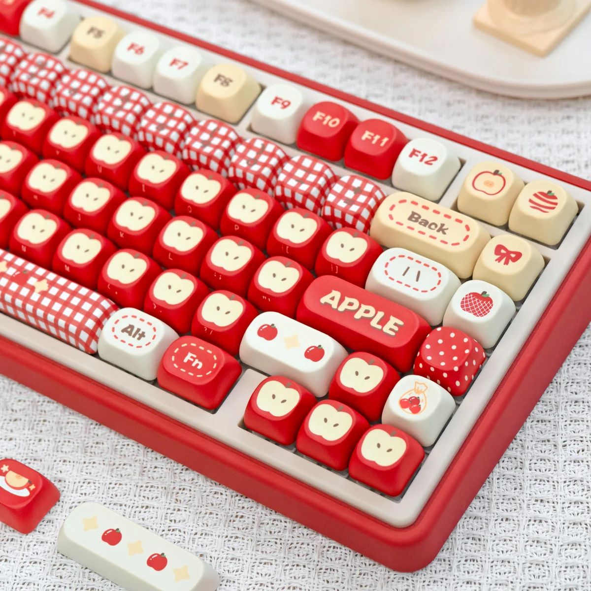 Various angles of the playful 'Apple' UR82 Tri-mode Mechanical Keyboard, highlighting its compact ergonomic design and vibrant RGB lighting.