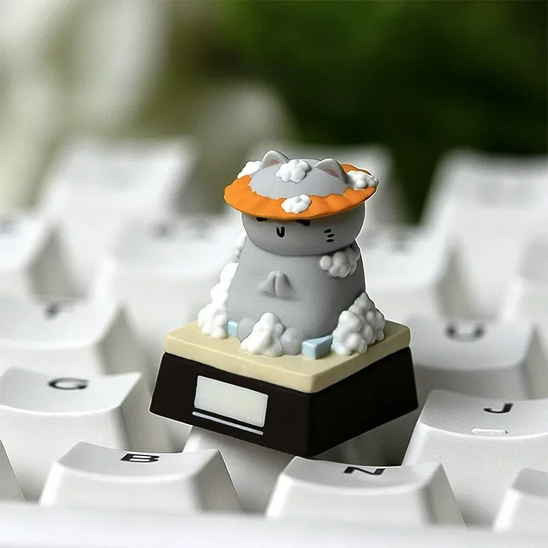 Whimsical resin artisan cat keycap, viewed from multiple angles, featuring an expressive feline illustrating a funny work mood, adding charm to your keyboard.