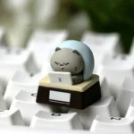 Detailed view of a whimsical handcrafted resin artisan cat keycap, capturing an expressive feline in a relatable work mood, showcasing its unique design.