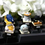 Whimsical handcrafted resin artisan cat keycap featuring an expressive feline illustrating a relatable work mood, perfect for keyboard enthusiasts.