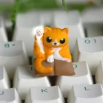 A whimsical artisan cat keycap, handcrafted from vibrant resin, features a playful cat in a unique cleaning pose. Intricate details are showcased.