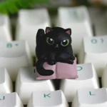 This handcrafted whimsical cat cleaning artisan resin keycap for ESC features a playful cat character in vibrant resin, showcased from a detailed angle.