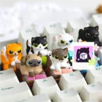 Whimsical handcrafted artisan resin keycap featuring a playful cat in a cleaning pose, showcasing intricate details from a unique angle.