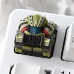 Close-up of a Scavenger Furnace Artisan Keycap, showcasing its handcrafted molten resin with fiery translucent glow and dystopian details.