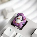 Artistic handcrafted Whimsical Lying Flat Duck Artisan Resin Keycap, showing its adorable, relaxed duck design and vibrant resin from a unique side angle.