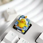 Close-up of the whimsical lying flat duck artisan resin keycap, handcrafted with vibrant details from a unique angle, showcasing its adorable, relaxed motifs.