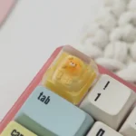 Close-up of a Bear Bread Transparent Keycaps, showcasing its adorable miniature bear shape and vibrant pastry details.