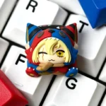 Close-up of a whimsical grotesque doll artisan resin keycap, highlighting the intricate handcrafted details and slightly eerie aesthetic from a unique design.