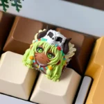 Close-up of a unique handcrafted tribal Matata artisan resin keycap for the ESC key, showcasing vibrant patterns and earthy tones.