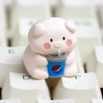 Collection of playful handcrafted resin artisan pig keycaps, showcasing vibrant details of whimsical pigs enjoying snacks from various angles.