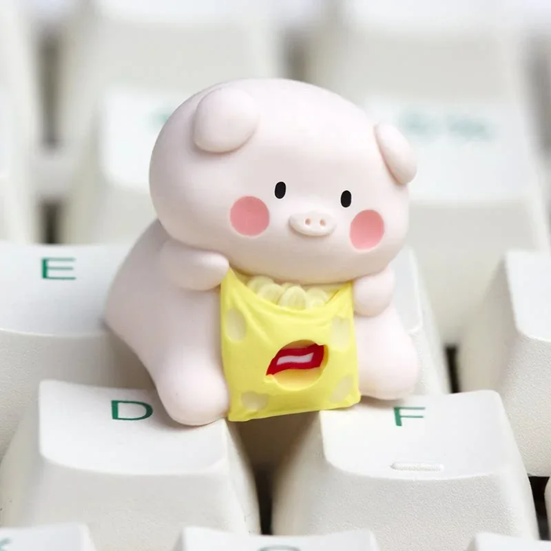 A playful artisan resin keycap featuring a whimsical pig character enjoying a snack, showcasing the vibrant handcrafted detail and unique design.