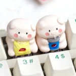Unique handcrafted artisan resin keycap featuring a playful pig enjoying a snack, adding vibrant, whimsical charm to any desk setup.