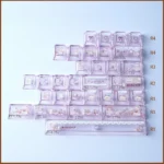 Whimsical Bear Tea Party PBT keycaps set close-up, revealing charming pastel illustrated bears and tea party elements. Durable PBT set for a joyful, playful design.