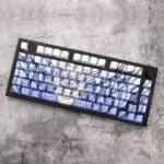 A collection of blue PBT keycaps showcasing their side-engraved legends and backlit transparency from various angles, highlighting their durable Cherry profile.