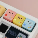 Iconic BMO ESC keycap from various angles, showcasing its handcrafted translucent design, whimsical charm, and vibrant retro-futuristic hues.