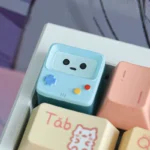 Close-up of the whimsical translucent BMO ESC keycap, highlighting its vibrant colors and handcrafted details from a unique angle, capturing its playful design.
