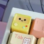 A detailed view of the handcrafted BMO ESC keycap, revealing its iconic design and vibrant translucent material with a playful, retro-futuristic charm.