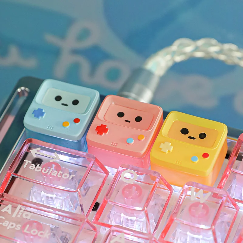 A charming, translucent BMO ESC keycap showcasing its iconic design and handcrafted quality. This whimsical accent brings a retro-futuristic animated design.