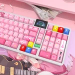 A vibrant, close-up view of the exclusive Bocchi the Rock! Hitori Gotoh PBT keycaps set, showcasing playful anime art and musical notes.