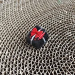 Handcrafted black resin gift keycap for ESC key, featuring a delicate ribbon and bowknot, evoking a miniature artistic present.