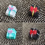 Artistic handcrafted resin gift box keycap featuring a delicate bowknot and translucent finish, perfect for custom ESC keyboards.
