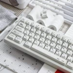 Various angles of the premium Braun PBT keycaps set, highlighting their unique irregular white texture and minimalist design, embodying vintage Braun elegance.