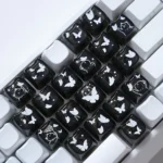A vibrant close-up of glowing butterfly heart keycaps set, highlighting their translucent PC design and whimsical, illuminated details for a delightful design.