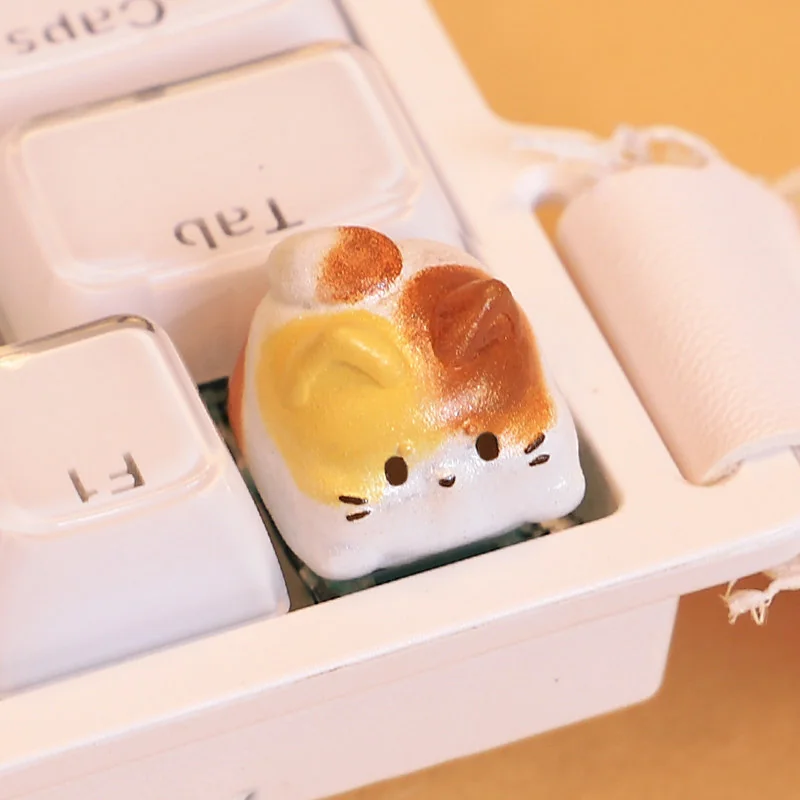 Handcrafted resin Calico Cat Keycap, multiple views. Adorable, intricately sculpted calico kitten design, a whimsical artisan charm for your desktop.