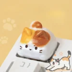 Close-up of a handcrafted resin Calico Cat Keycap, featuring an adorable, intricately sculpted calico kitten design, adding whimsical artisan charm.