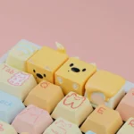Close-up of a whimsical candy puppy resin ESC keycap, showcasing its playful pose and meticulous handcrafted details from a unique angle. Perfect for dog lovers.